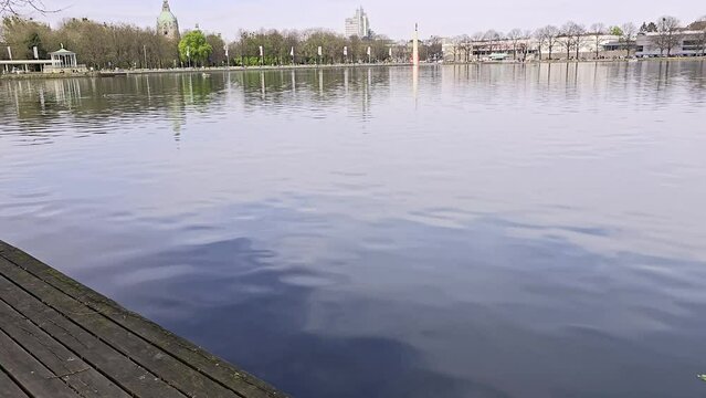 Wooden deck transformed with cleaning and painting against lake backdrop Maschsee Hanover