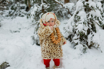 Girl in winter clothes eating bagels