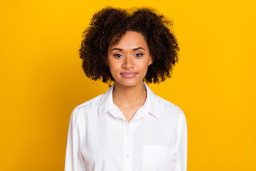 Obraz na płótnie Canvas Portrait of attractive skilled cheerful wavy-haired girl expert wearing white shirt isolated over bright yellow color background