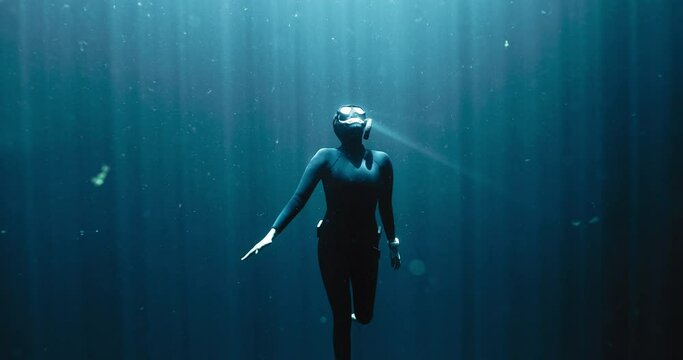 Closeup of a Diver going up with the sun rays