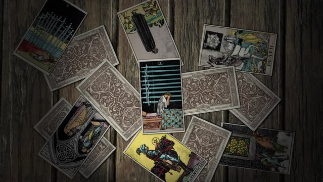 Oslo, Norway - January 11, 2021. The mysterious tarot card Nine of Swords depicts a woman sitting up in her bed holding her head in her hands. A mysterious card for future predicting. Mysterious card.