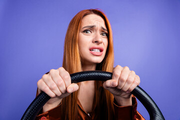 Portrait of nice young woman hands hold wheel wear brown shirt isolated on purple color background