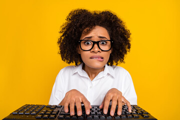 Portrait of attractive frustrated scared desperate wavy-haired girl typing text biting idea...