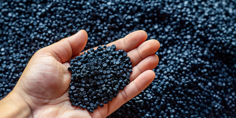 Hand Holding Black Plastic Resin Pellets for Plastic Manufacturing, Overmolding, Low Pressure Overmolding, and Injection Molding Materials