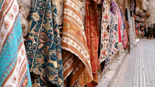 East market. Scarves with national patterns are hung for sale