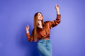 Portrait of nice young woman enjoy dancing wear brown shirt isolated on purple color background