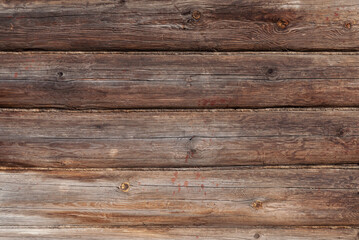 Texture of old weathered unpainted wooden log wall