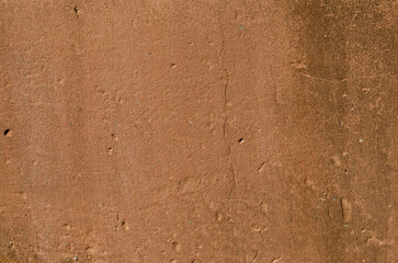 texture, old wall with clay plaster, full of holes, cracks and mold