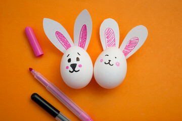 Food photo. Greeting card for Happy Easter. White chicken egg with cute bunny face and rabbit ears...