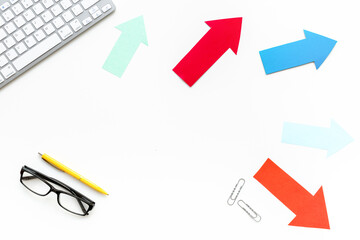 Paper arrows on office desk - business problem solving options