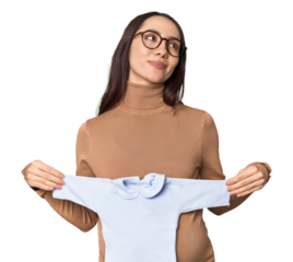 Pregnant Caucasian with blue baby onesie