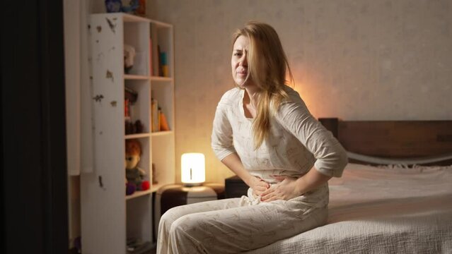 Woman stomach pain woman suffering from stomach ache, holding belly, feeling abdominal or menstrual pain. Gastritis, diarrhea and painful periods concept