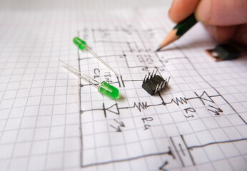 Hand drawn electronic circuit diagram and semiconductor components. Project planning, design and production in electric - electronic industry. Selected focus.