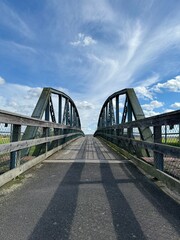 ancient bridge over the river against the background of the sky with clouds