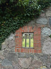 window in antique masonry made of brick and natural stone