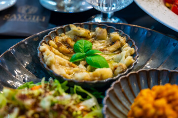 Vegetarian dishes, mezze in Turkish restaurant, bulgur pilaf, grilles eggplants and fresh vegetables salad
