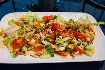 Green vegetables salad for turkish mixed grill meat, chicken wings, lamb, beef shashlik, kebab in restaurant