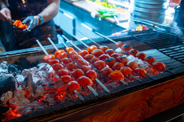 Barbecue with ripe red tomatoes on charcoal grill in turkish restaurant