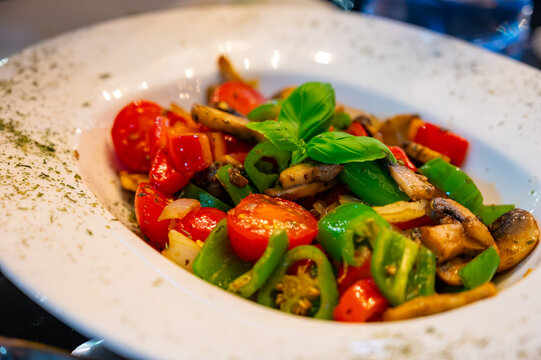 Vegetarian dishes, mezze in Turkish restaurant, grilles mushrooms, pepper and fresh vegetables salad