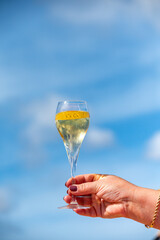 Pouring a glass of champagne on vacation, south of Fuerteventura, Canary islands, blue ocean, mountains