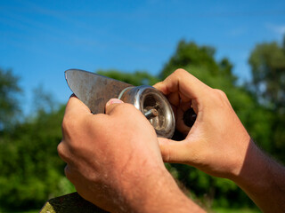 Close-up of the blade change on the grass mowing trimmer. Maintenance of equipment