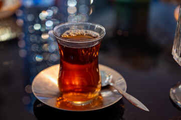 Turkish sweet tea served in traditional glass in restaurant in Istanbul, Turkey