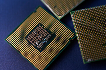 A computer processor on a blue background. Contacts on the processor case.