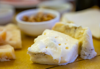 Cheese tasting, piece of italian blue cheeses gorgonzola dolce and picante with blue mold from north of Italy close up