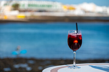 Glass of cold sangria wine served with orange in beach cafe, Corralejo, Fuerteventura, Spain