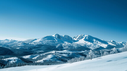 The serene beauty of a snow-covered mountain range under a clear winter sky, against a steel blue background.