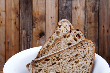 Three slices of wholemeal bread with a rustic wooden background
 - Powered by Adobe