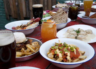 Celebration. Closeup view of the restaurant table with exquisite dishes, cocktails and beer. 