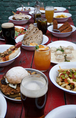 Celebration. Closeup view of the restaurant table with exquisite dishes, cocktails and beer.