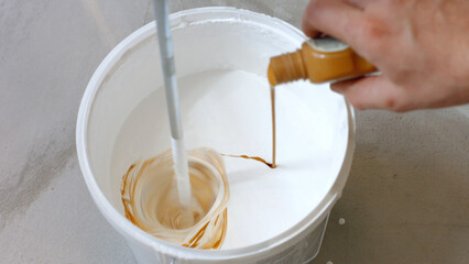 Dilution the paint mixer. Painting of white paint. Mixing the solution.