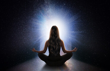 woman meditating front the universe
