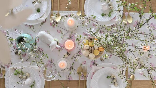 Spring Easter decor. Easter table setting. Flowers and dishes and candles for a festive dinner. High quality 