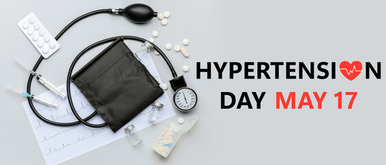 Sphygmomanometer, cardiogram and pills on light background