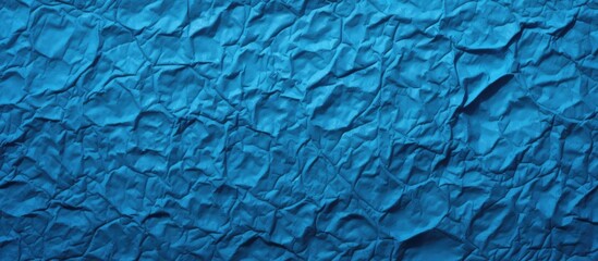 A closeup of a textured aqua blue wall resembling a woven fabric pattern, giving off an electric...