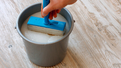 Wallpaper glue. Preparation of construction glue in a bucket.