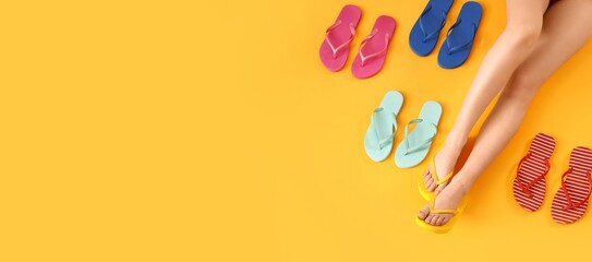 Female legs with different colorful flip flops on yellow background with space for text - obrazy, fototapety, plakaty