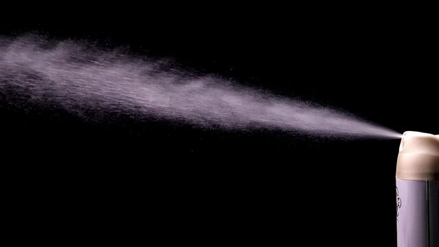 A stream of splashed liquid from a spray can. Deodorant antiperspirant. Air freshener.