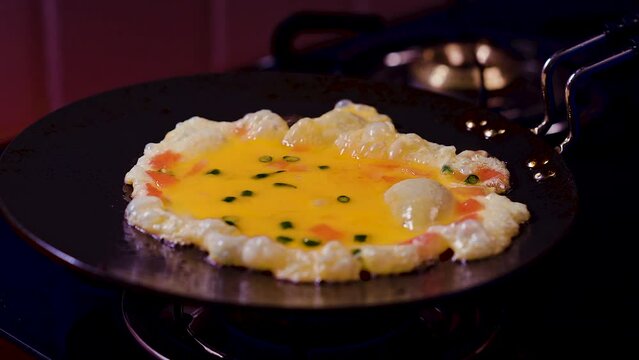 Spring fried omelet making in frying pan on kitchen