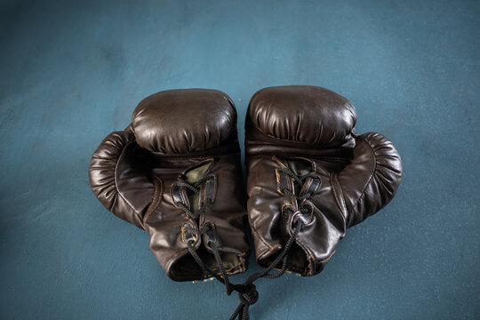 black boxing gloves, studio settings, sports concept stock photo, blue, gray background