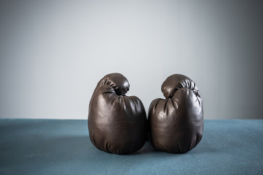 black boxing gloves, studio settings, sports concept stock photo, blue, gray background