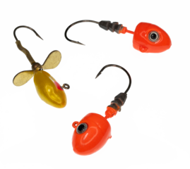 Three brightly colored fishing jig lures on a transparent background. The jigs are colored yellow or orange and have large eyes. The jigs are arranged in a triangle pattern.
