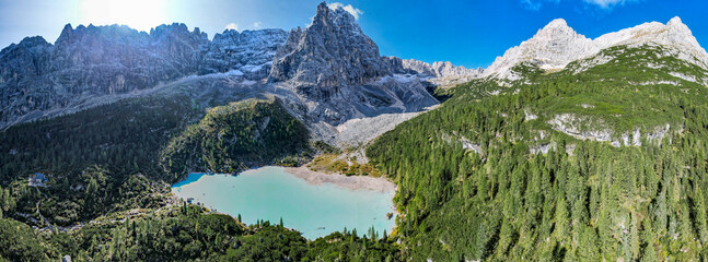 Lake Sorapis in the Dolomites Italy - Aerial view of beautiful mountains lake with snow capped peaks in the background