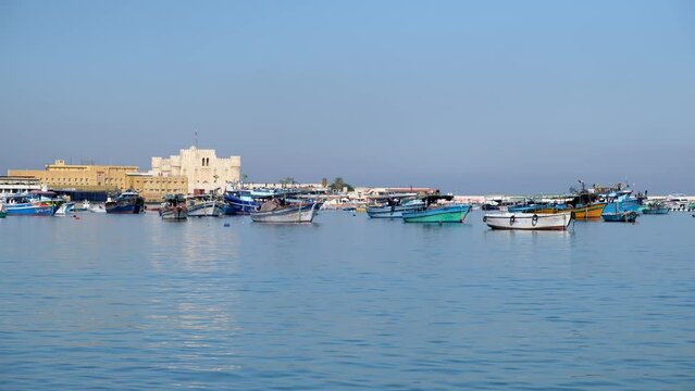 Boats in a harbor in front of Qaitbay fort. Citadel of Qaitbay, Alexandria, Egypt