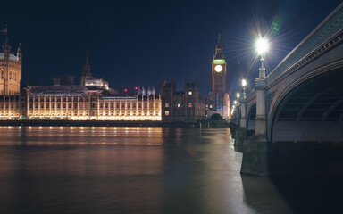 The Parliament, the Big Ben and the Westminster bridge at night, London, England