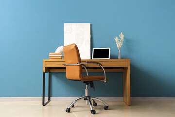 Stylish workplace with modern laptop and comfortable armchair near color wall