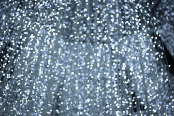 raining white blue light neon bokeh with dark black grey background , Festive defocused lights.